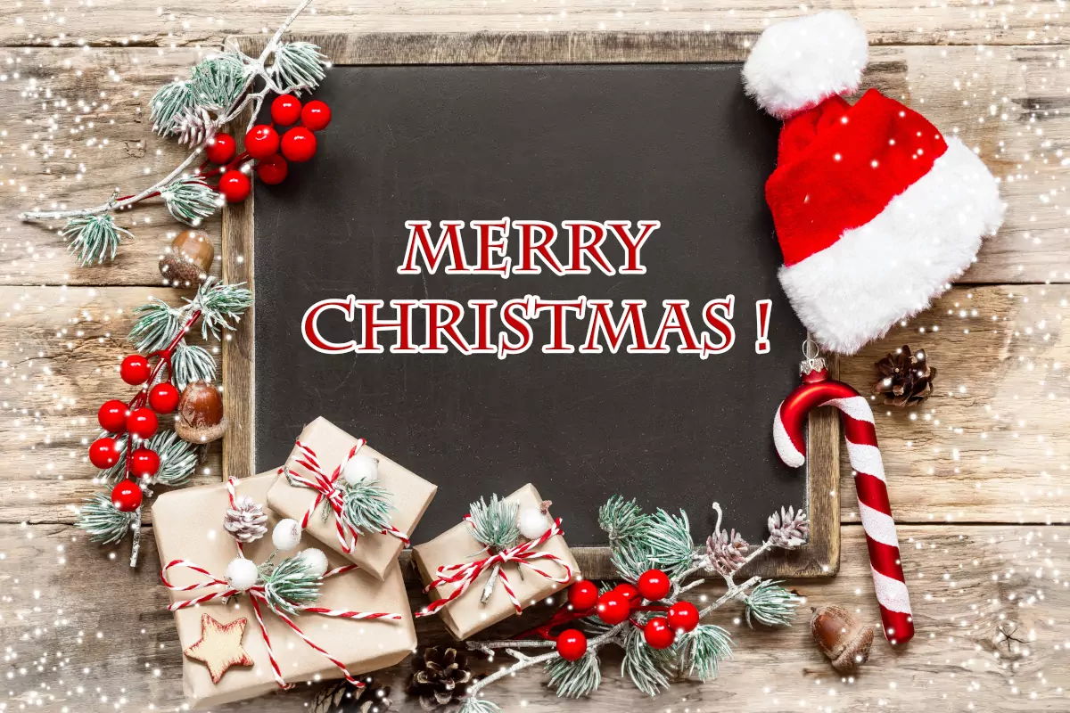 'Merry Christmas' on Blackboard Surrounded by Misletoe, Presents, Candy Cane, and Santa Hat