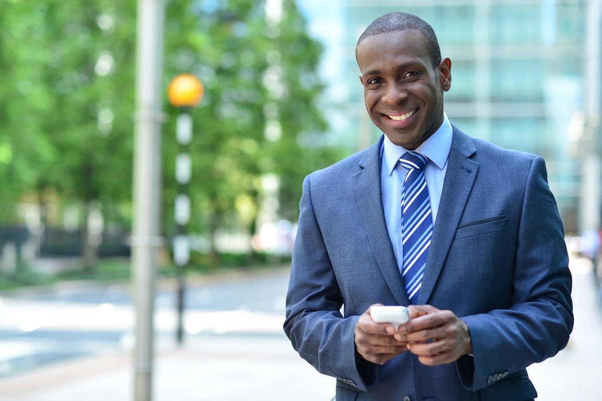 Smiling Business Man Holding Cell Phone