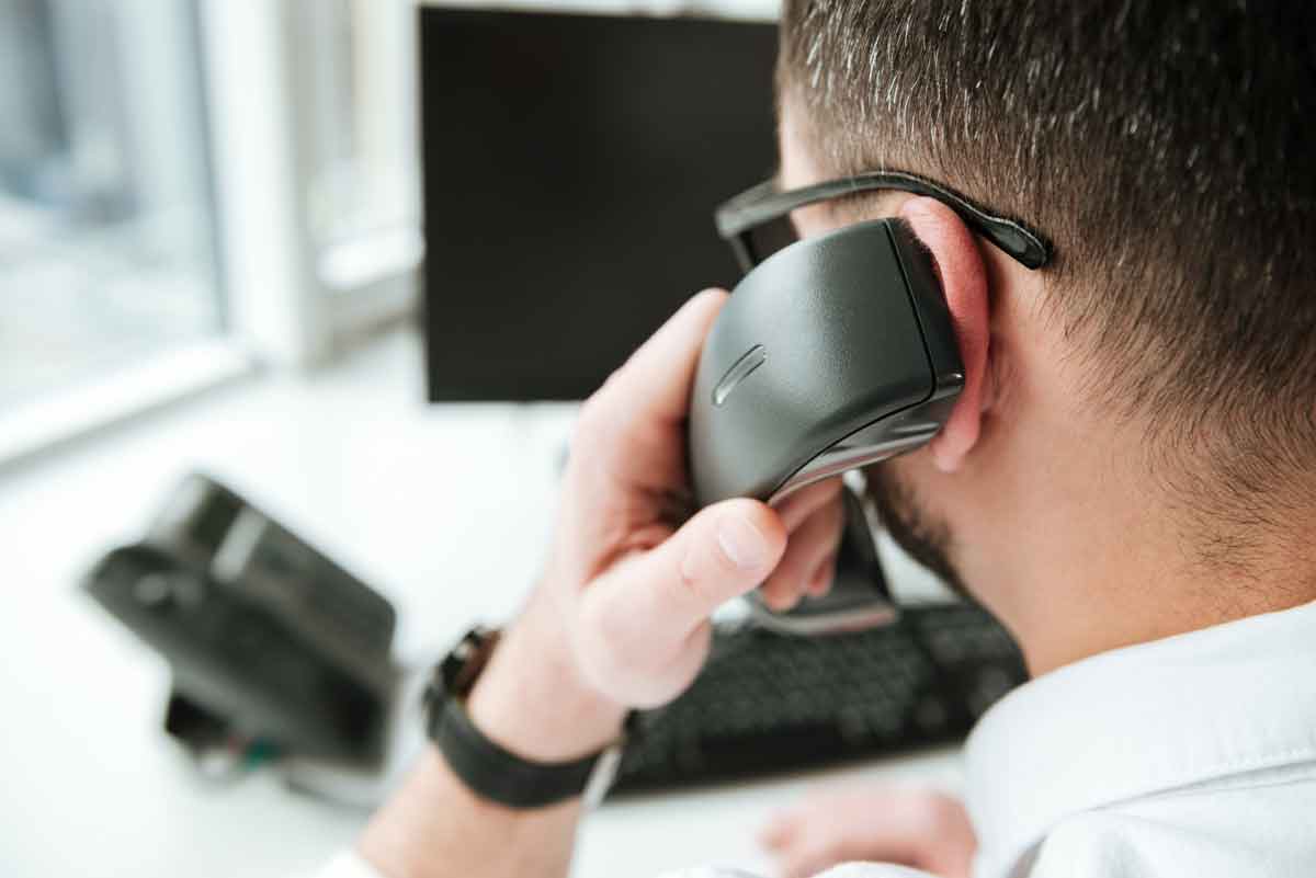 Back of Man's Head with Phone Receiver Held to Ear