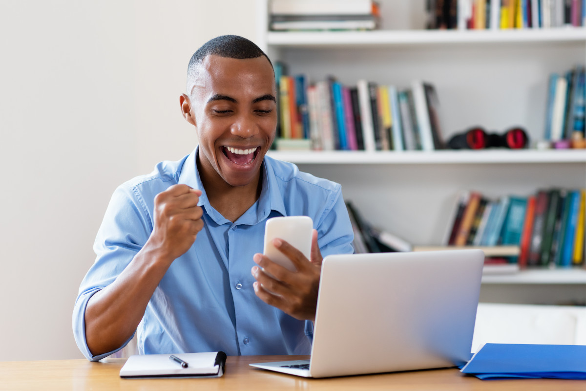 Happy man reading text message