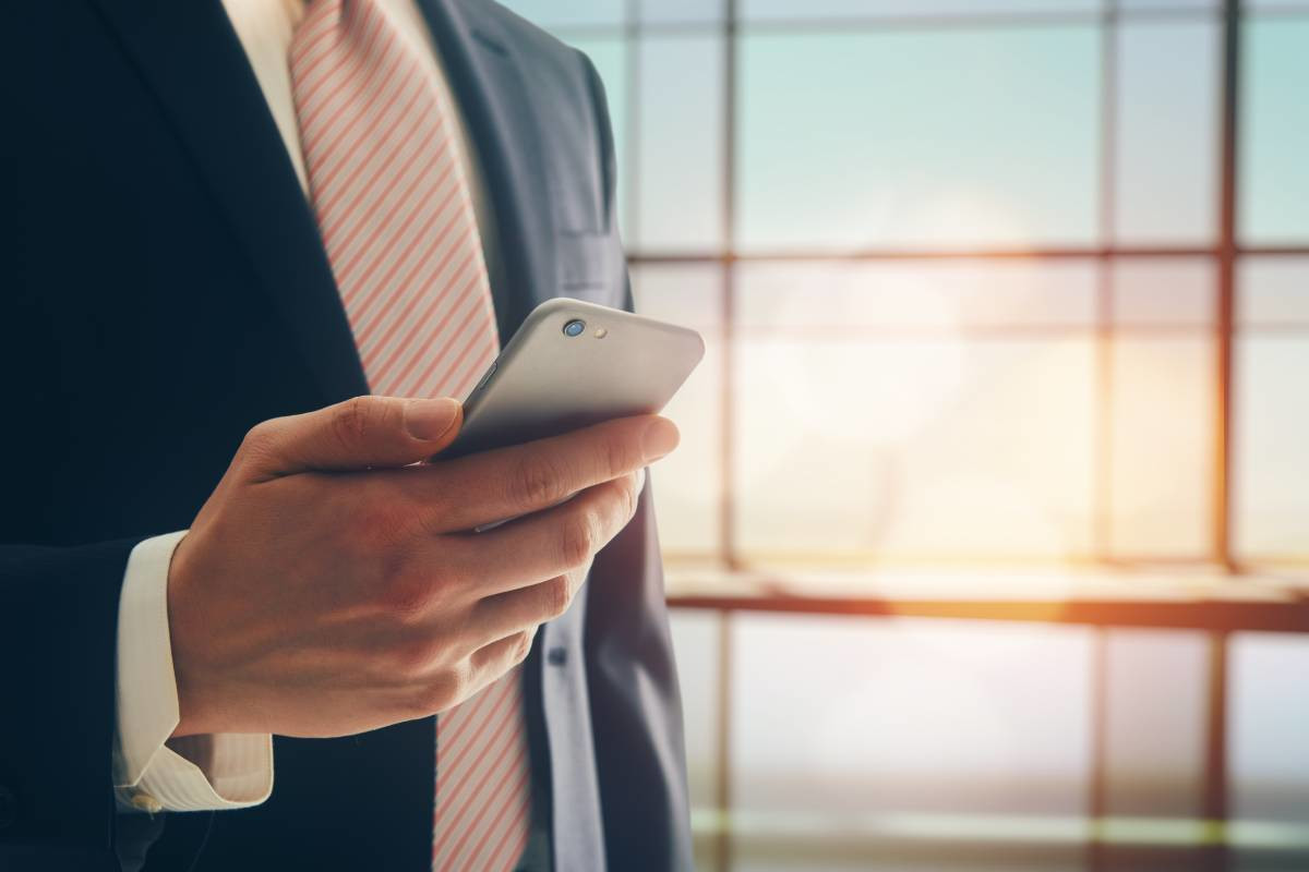 A businessman looking at his cell phone