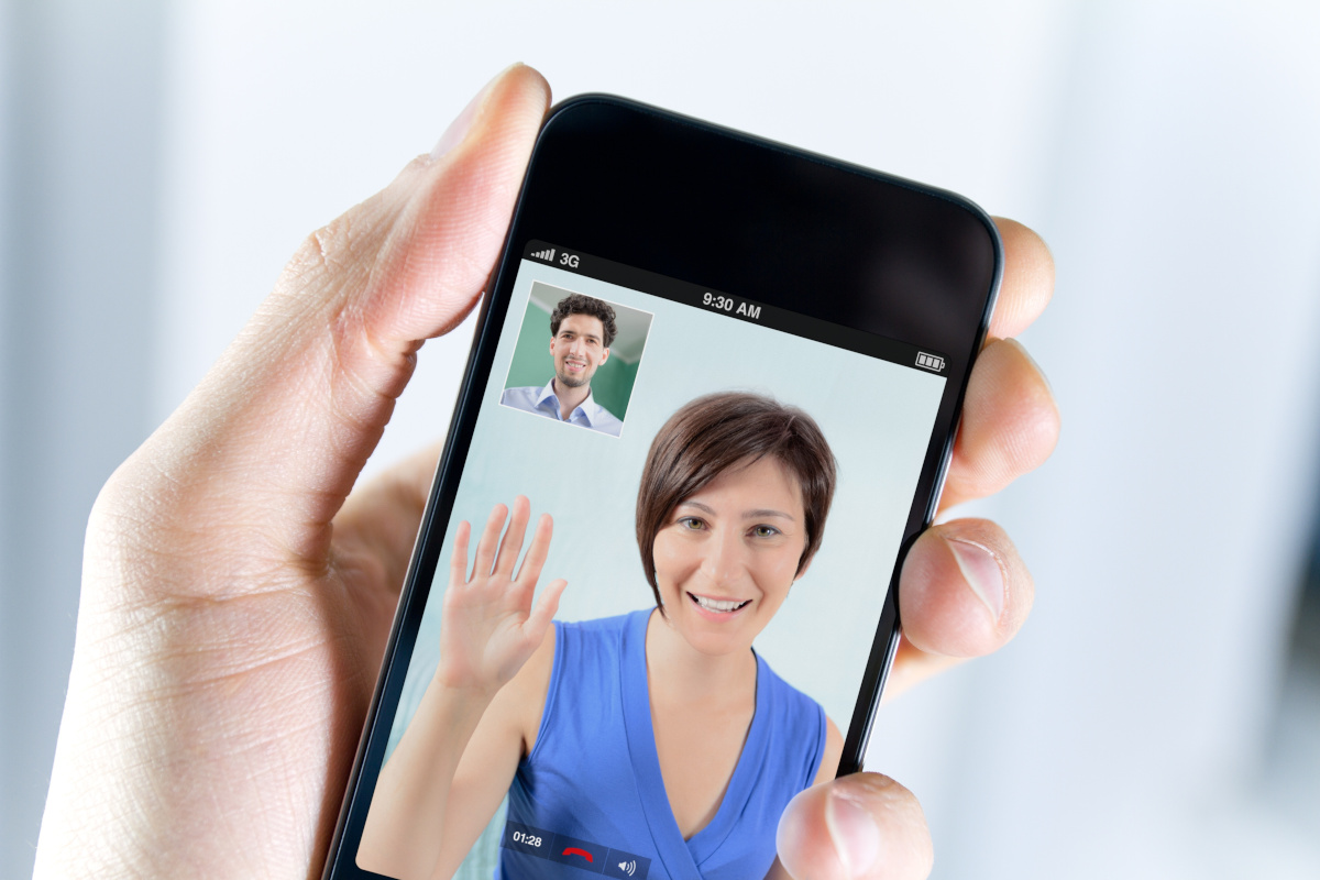 Two people video conferencing with mobile phones