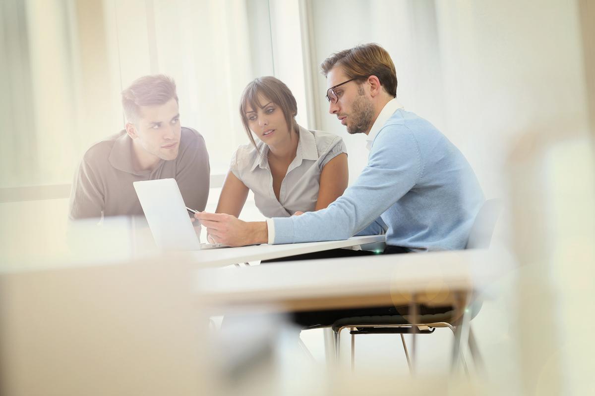 Three business people having a meeting