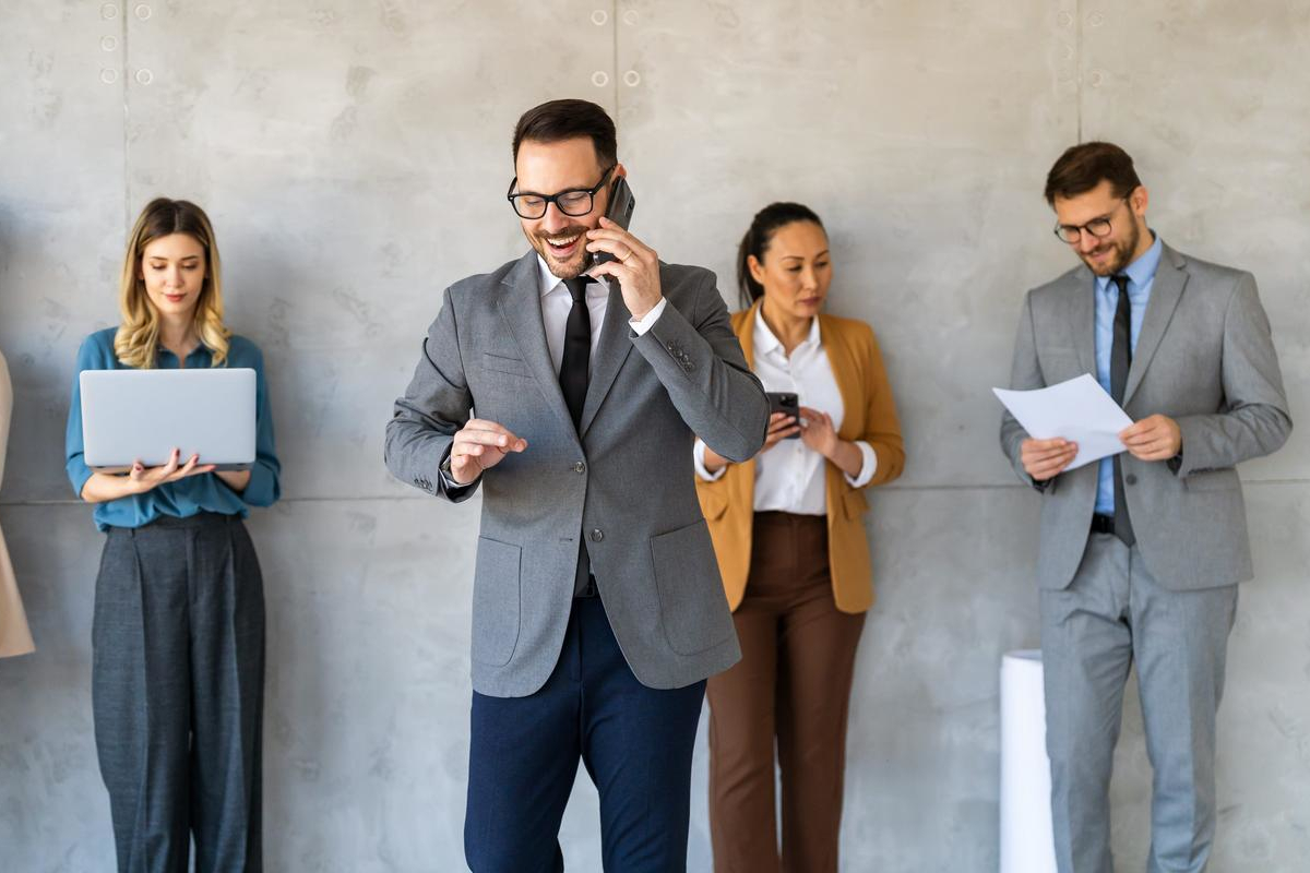 Business people working on mobile devices.