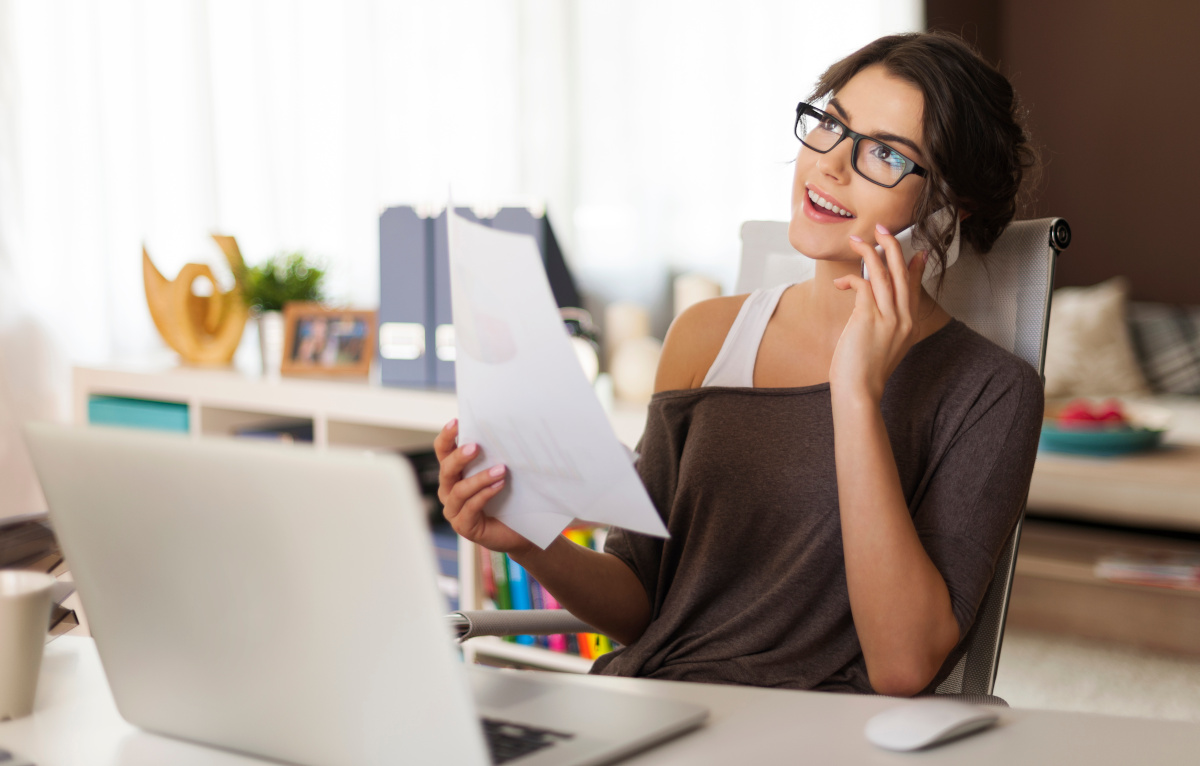 A woman working from home while talking on her cellphone