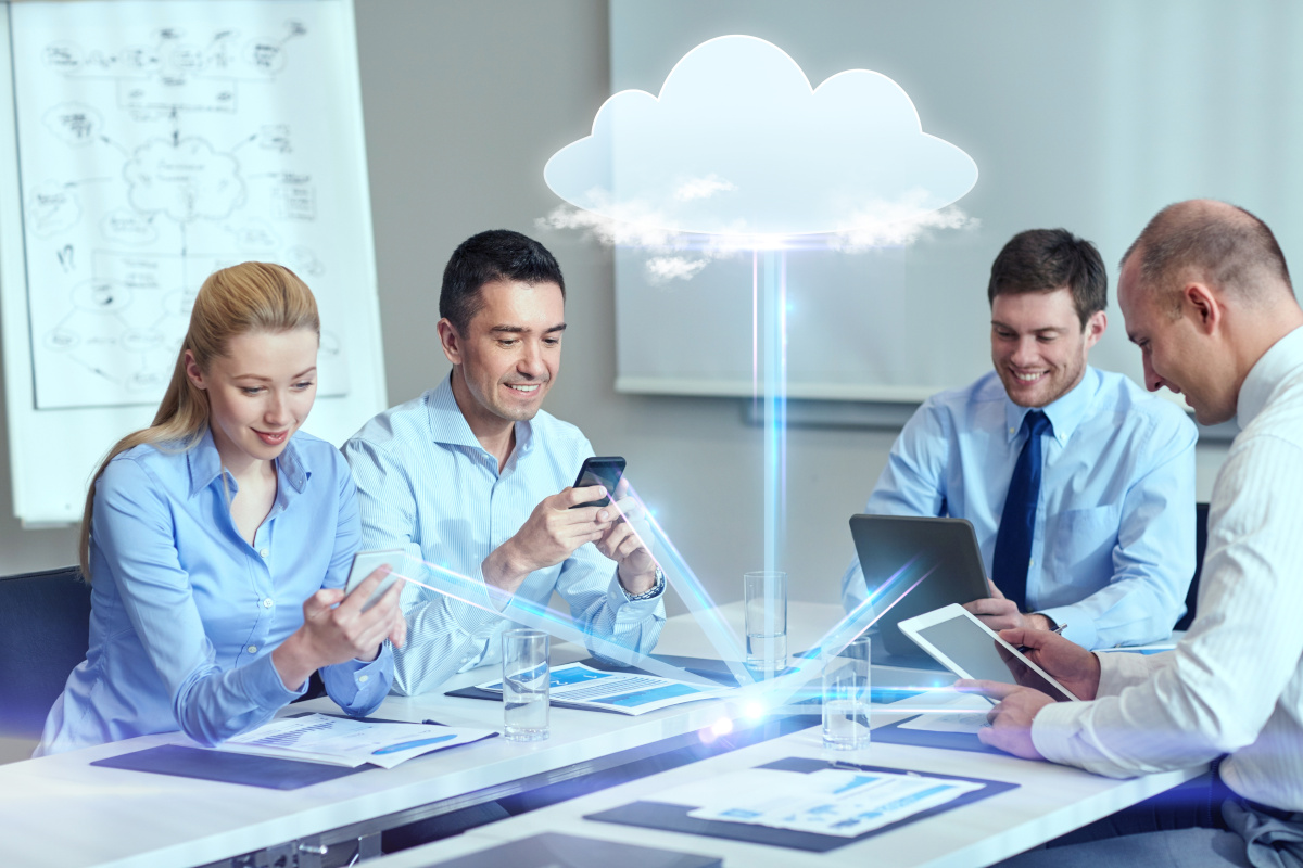 A group of people at a table with devices that all connect and provide unfieid communications