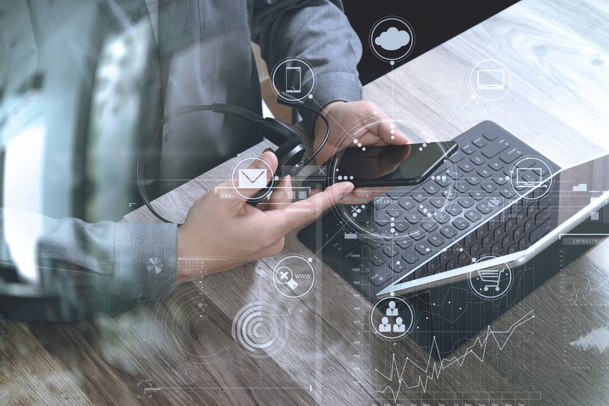 A man using a laptop and a headset with technology icons overlaid