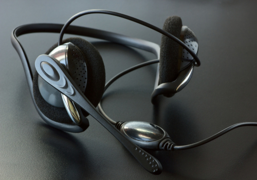 Close-up of a Plantronics headset, highlighting its modern design and adjustable microphone for clear audio communication.